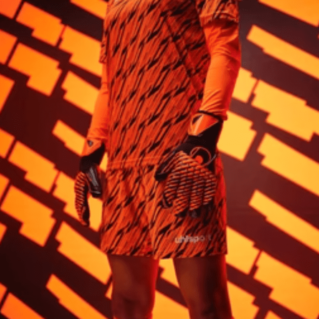 Goalkeeper wearing orange kit.